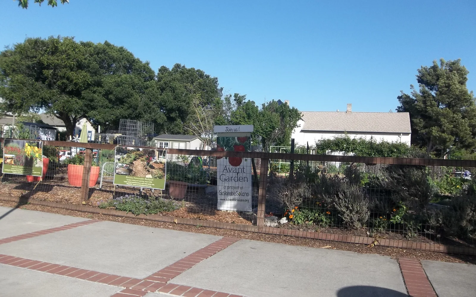 A community garden with raised garden beds and shared green space for neighborhood cultivation