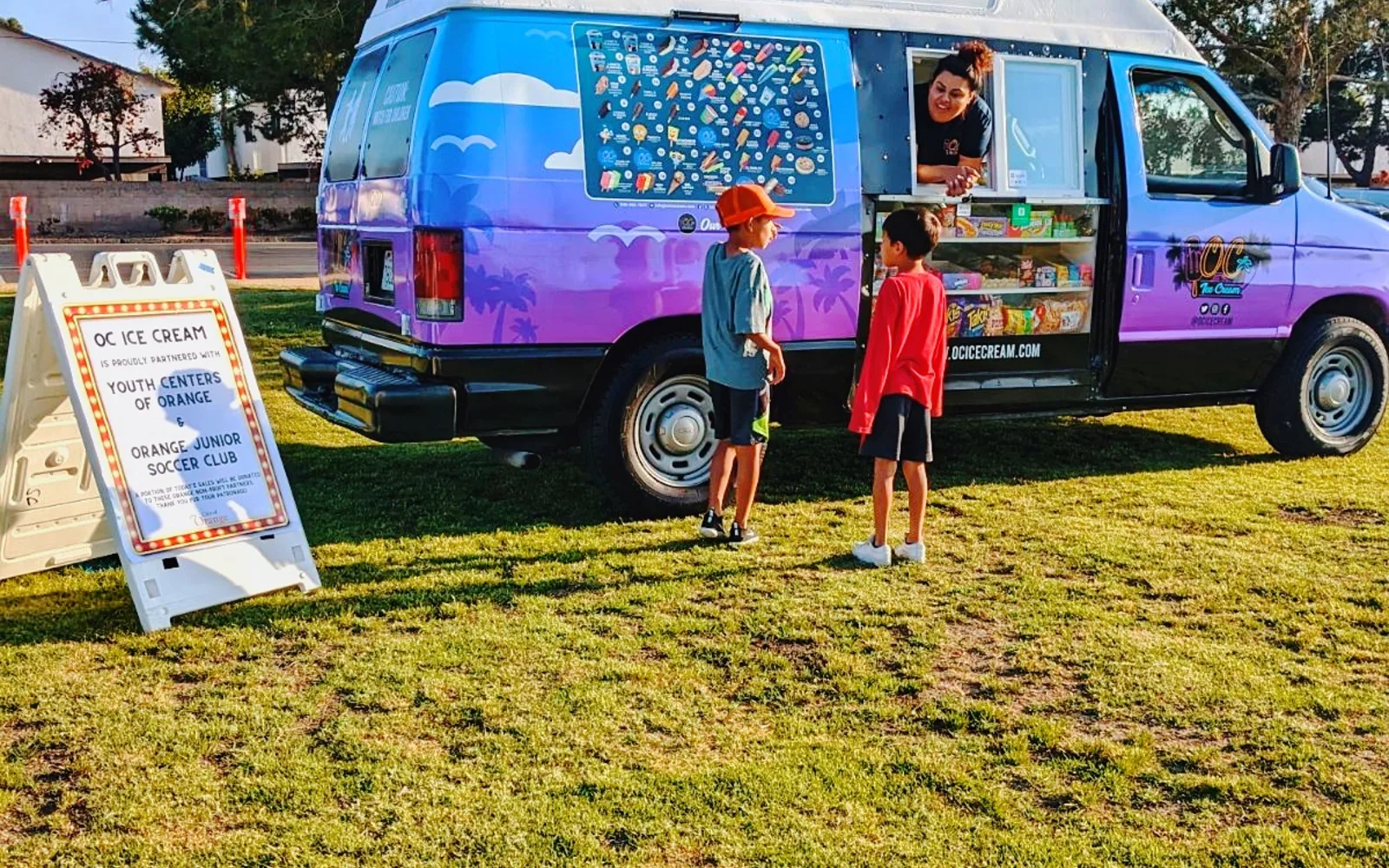 An ice cream truck serving children at a public park in Orange County, California
